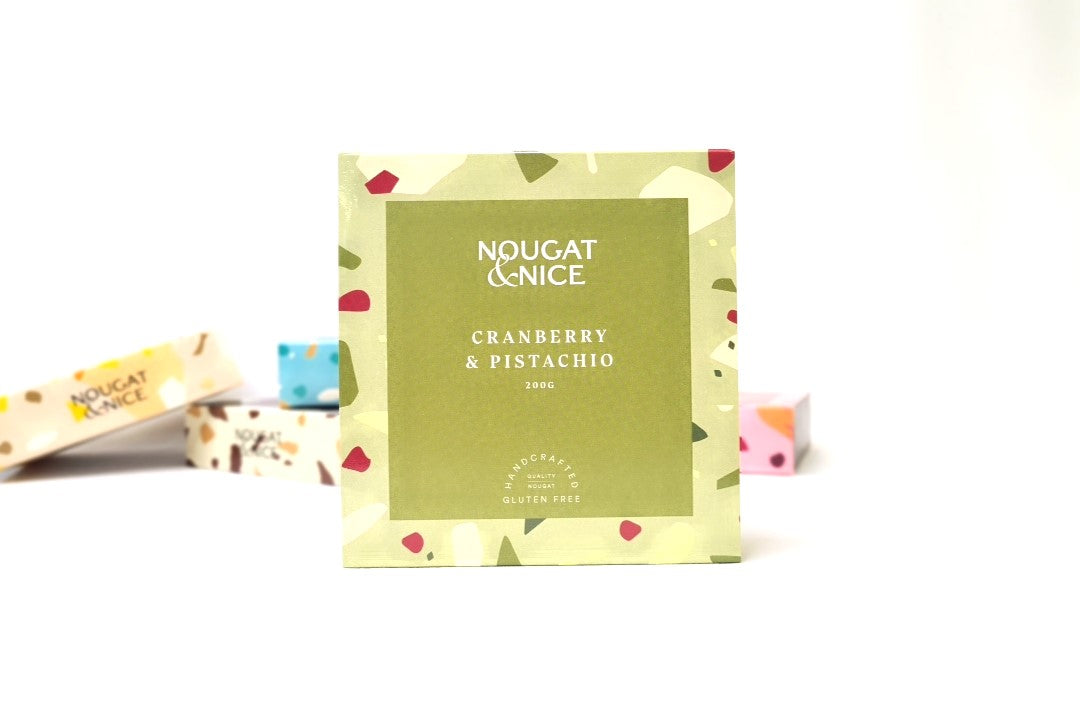 Indulge in our delightful nougat treat, blending natural honey with creamy pistachios and dried cranberries. Handmade nougat with care, our 200g Boxes offer versatile flavors perfect for cooking or dessert. These sleek boxes make the perfect ready-to-send  nougat gift, with a personalized message. Made with the finest ingredients, Nougat & Nice products are handcrafted for a creative twist on classic nougat.