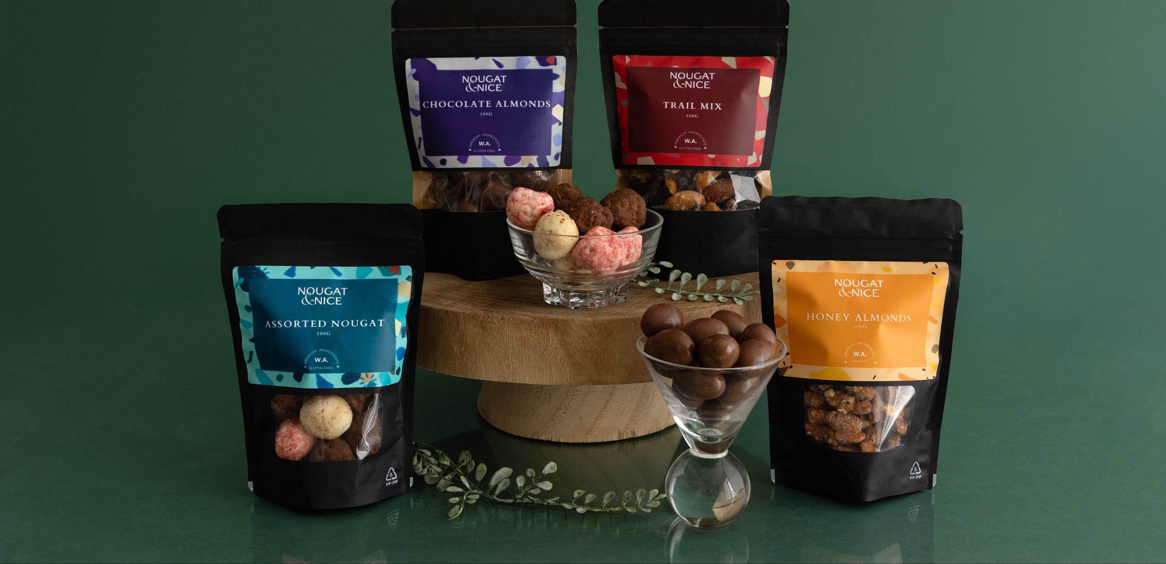 Assorted chocolate truffles in black bags on a green background