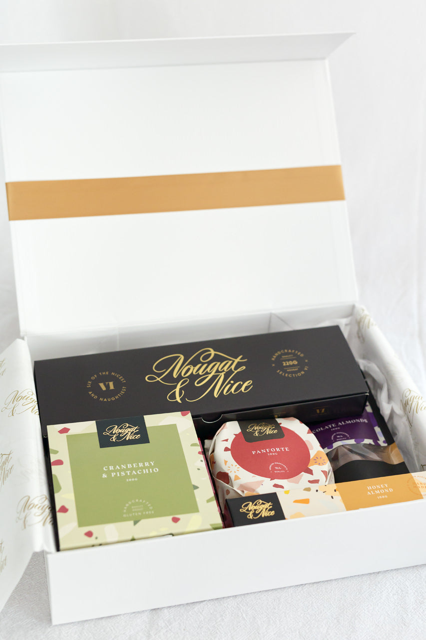 Experience our Large Variety Gift Box from the makers and creator at Nougat and Nice. This gift box contains 1x Signature Tasting Box, 2 x nougat 100g bars, 2x nougat 200g boxes and 2x pouches and 1x Panforte. Here at Nougat and Nice we source only premium ingredients and put love and care in to every detail. This gift box has been carefully and thoughtfully curated to make for the best Christmas gift , house warming present, real-estate gifts, baking box or for end of year corporate gifts.